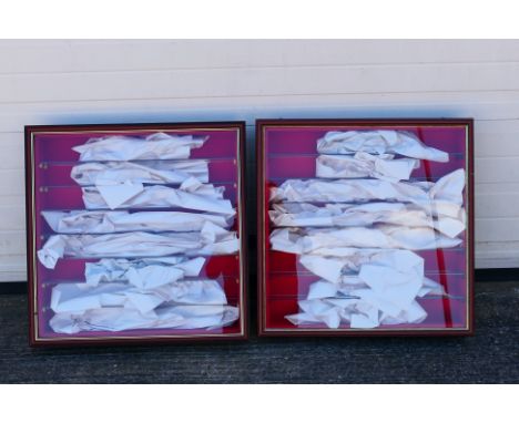 Two wall mounted glass display cabinets. Cabinets measure approximately 65cms (H) x 61cms (W) x 11cms (D), and feature full w