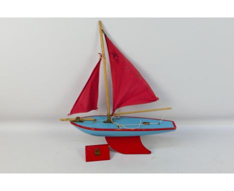 Star Yachts - A vintage wooden Star pond yacht in blue with red trim and sails # SY3. The model shows some signs of age and u