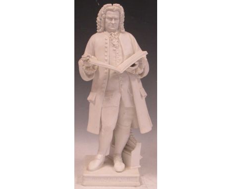 A Parian figure of Johan Sebastian Bach, standing holding an open score of St. Matthew's Passion, on a square socle, 40cms hi
