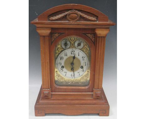 An Edwardian walnut case gong chiming mantel clock with arch top above chime/silent and slow/fast dials. 45cm x 30cm x 23cm