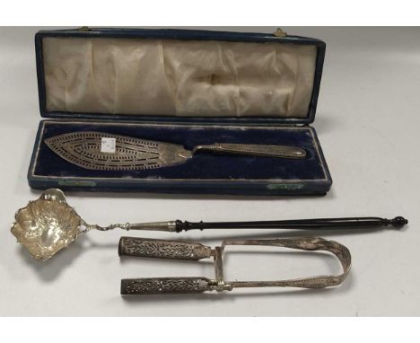 A pair of Victorian silver asparagus tongs together with a Georgian silver toddy ladle and a silver fish serving blade in a f