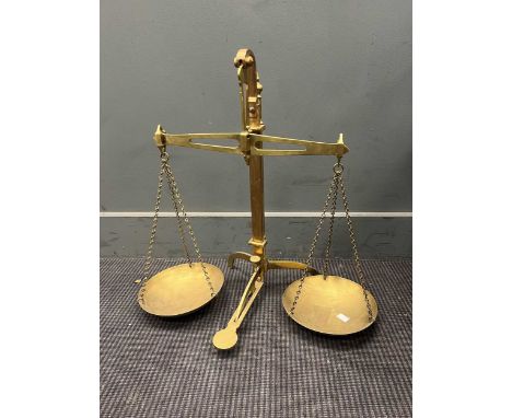 A set of brass weighing scales by L. Mattwood BHAM, with two dishes and central pedal lever release 55cm high