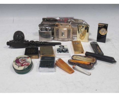 A box of assorted smoking equipment to include zippo, pipes amber cigar holder etc
