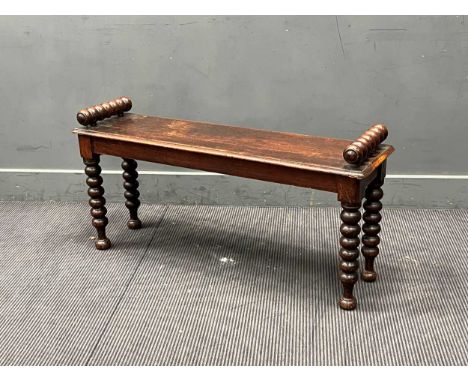 An oak window seat, late 19th century,with raised turned handles over a solid seat on bobbin turned legs53 x 107 x 30cm