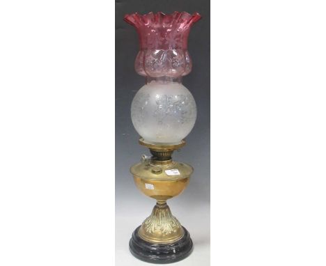 A late Victorian brass oil lamp with etched glass shade and chimney, together with a ruby glass shade with scalloped rim55cm 