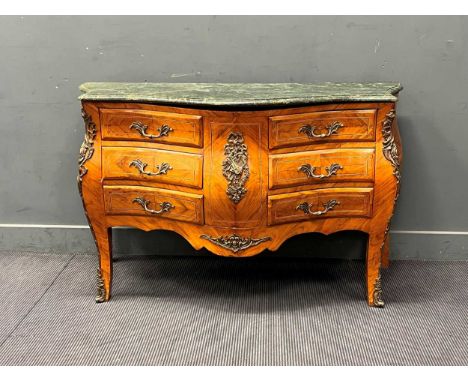 A Louis XV style marble topped gilt metal mounted commode, of bombe form and fitted with six short drawers, 89 x 138 x 47cm
