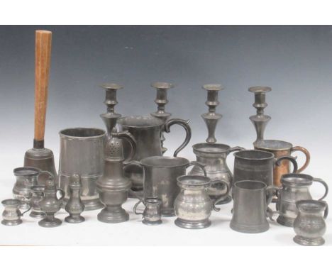 A collection of pewter to include a set of four knopped candlesticks, six tankards of various sizes, and eight variously size