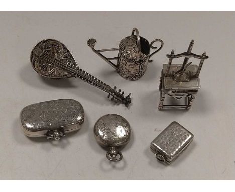 A silver double sovereign case, a silver sovereign case, a silver vinaigrette and three silver miniature objets, a watering c