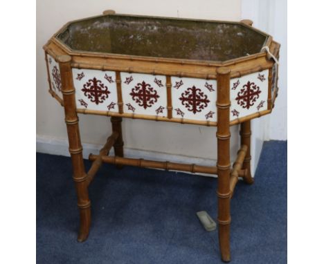 A Victorian tile inset faux bamboo planter with brass liner W.77cm