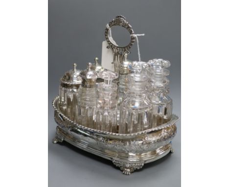 A Georgian composite silver eight-bottle cruet stand of shaped rectangular form, with wooden base, the stand circa 1820, scro
