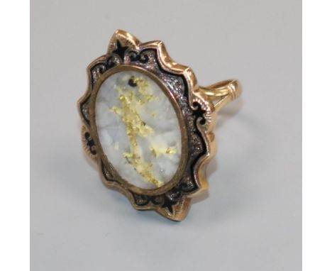 An early 20th century 9ct gold, quartz with iron pyrites and black enamel oval ring, size L.