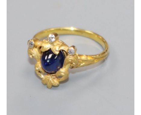 An early 20th century French? yellow metal, cabochon sapphire and diamond set dress ring, size L.