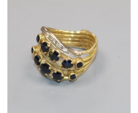 A yellow metal multi shank, sapphire and diamond dress ring, size K.