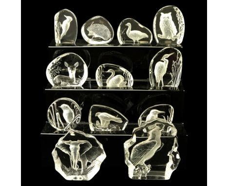 A large group of Matt Jonasson Swedish and other glass intaglio paperweights depicting animals and birds, tallest 17 cm