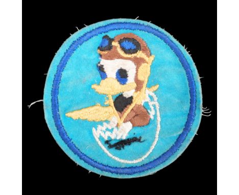 A United States Air Force Squadron cloth badge bearing the likeness of Donald Duck wearing a pilot's uniform 