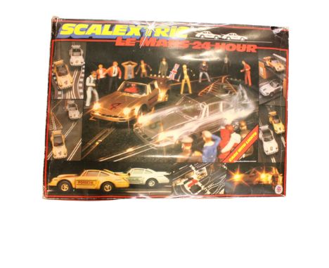 A large collection of Scalextric models, including boxed cars and tracks, buildings and accessories