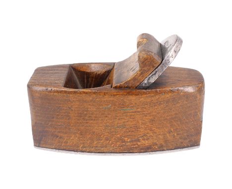 A diminutive antique beech wood smoothing plane with branded cast steel blade and steel shoe, 10 cm