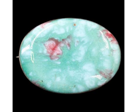 A George V Arts and Crafts white metal mounted Minton and Hollins Astra Ware high-fired ceramic cabochon brooch, 48 mm x 35 m