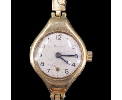A 1920s lady's 18 ct gold wristlet watch, having an exaggerated tonneau-shaped case, 33 mm x 21 mm, (running when catalogued)