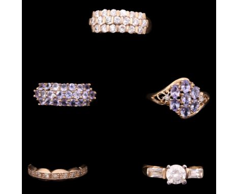 Four gemstone-set 9 ct gold rings together with a 9 ct yellow metal eternity ring, 15.8 g