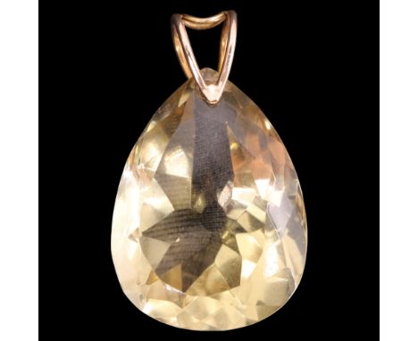 A large pendeloque-cut citrine pendant, the gemstone suspended on a 9 ct gold double-hoop bale, 36 mm, 10 g