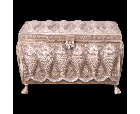 A white metal hinge-lidded table box or casket, high-relief-decorated in depiction of fish on a floral ground, having feet in