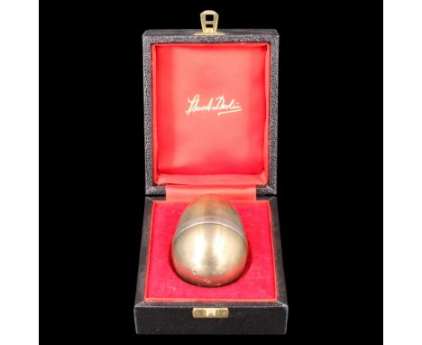 Stuart Devlin (1931-2018), a cased silver gilt 'Surprise' egg, having a slip-fit lid opening to reveal a pixie sat atop a toa