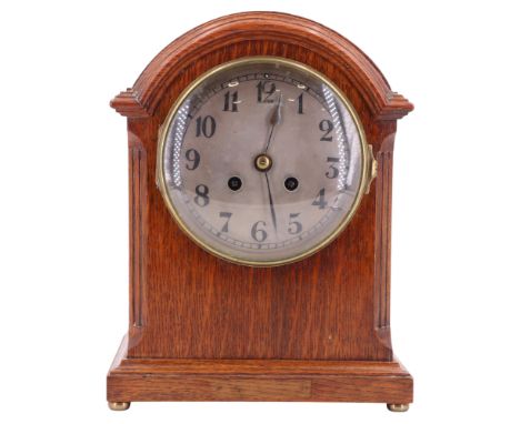 A late 19th / early 20th Century arch top oak mantel clock by Samuel Marti of Paris, having a two-train movement and striking