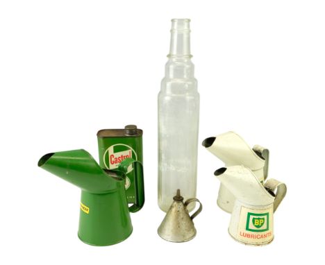 Three BP and Halfords tinplate oil jugs together with a Castrol XL can, an Essolube glass bottle and one other oil can
