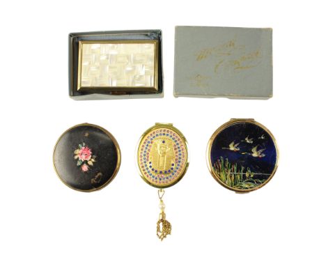 A Clover clockwork musical and two other vintage powder compacts, together with a kitsch Egyptianate purse mirror 