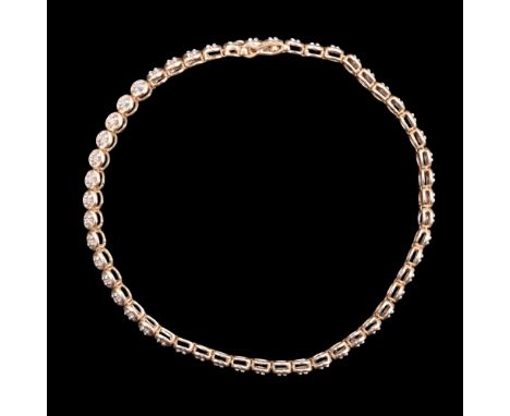 A diamond and 9 ct gold tennis bracelet, comprising small diamond brilliants each pellet-set within a gold annulus, 19 cm, 6.