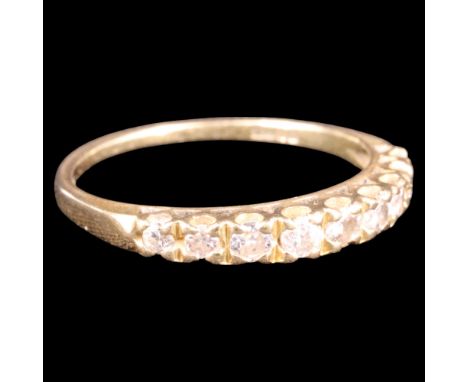 A contemporary diamond and 18 ct gold half hoop eternity ring, set with nine graded brilliants, largest stone 2 mm, M/N, 1.8 