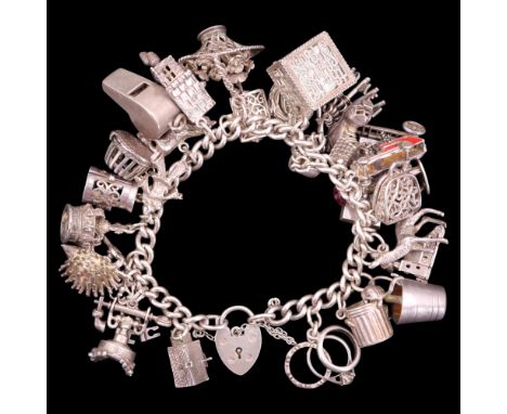 A 1970s silver charm bracelet having fire truck, bird's nest, telephone, cuckoo clock and other novelty charms together with 