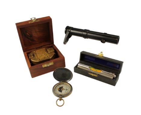 A pocket magnetic compass, circa 1940s, a reproduction compass, a cased spirit level and a spotting scope or sight