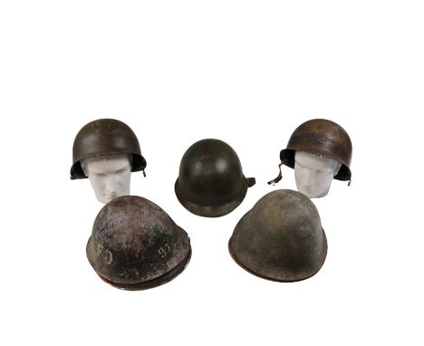 Three M1 type helmet shells together with four relic British MK IV shells