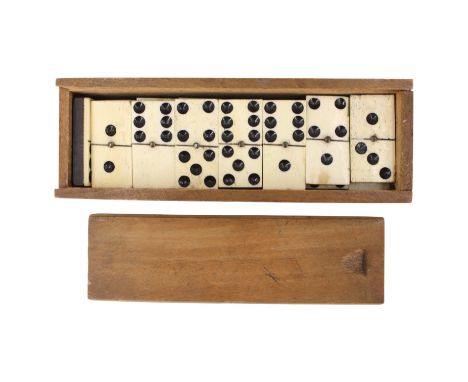 A Victorian set of bone and ebony dominoes, 17.5 cm x 6 cm x 5 cm