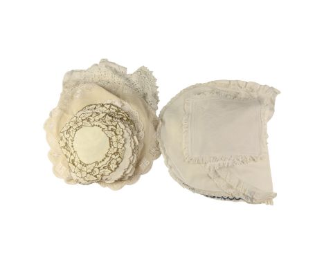 A group of vintage domestic textiles including tea cozies, lace doilies, etc