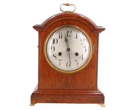 A late 19th / early 20th Century Junghans arch top oak bracket clock by W Wells &amp; Son of Stroud, having a two train movem