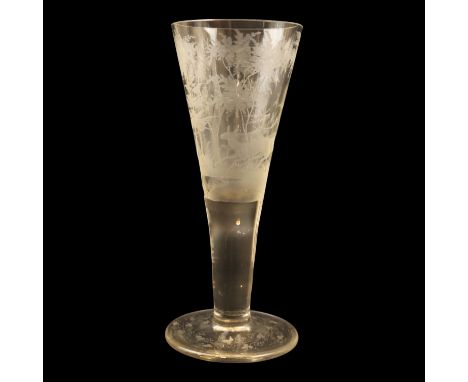 A late 19th Century cut-glass trumpet vase, wheel cut with a continuous depiction of a deer and two stags running through woo