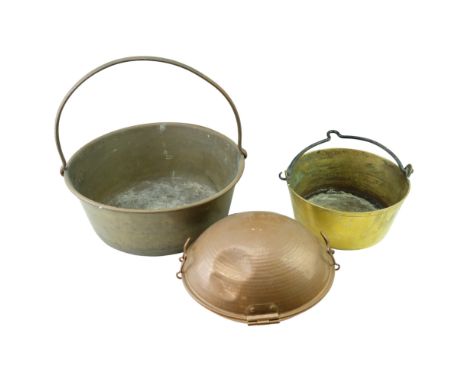 A large brass jam pan together with one other jam pan and a Portuguese cataplana copper cooking vessel