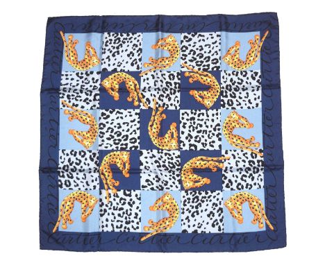 A Cartier silk scarf, the vari-hue blue ground with maker's Panthere detailing throughout, signed Cartier, with maker's box. 