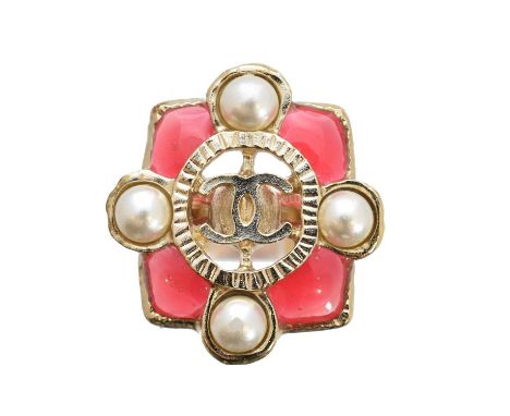 A Chanel dress ring, the maker's double C logo within a red enamel and imitation pearl rectangular surround, and grooved band