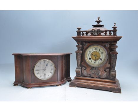A 1930's Germa0 8-day&nbsp; mantel clock having a tile roof design pediment above a round face with white enamelled chapter r