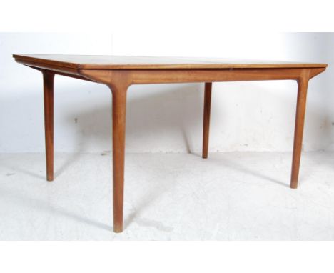 Macintosh of Kirkcaldy - A retro vintage 1970s teak wood extendable dining table of rectangular form. The draw leaf table ope