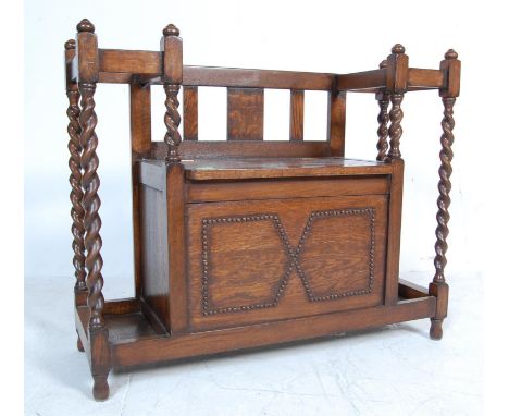 A 1930's Old Charm oak hall bench settle having a central bench with a hinged lid revealing chest within having a panelled fr