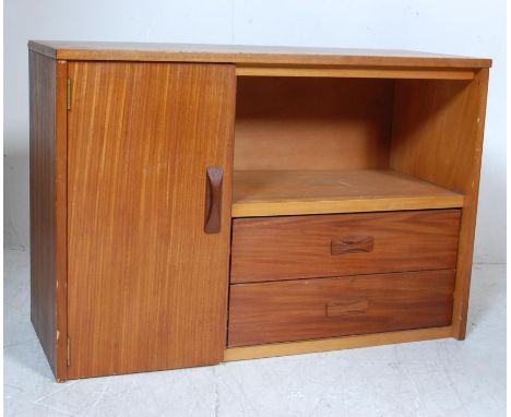 A retro vintage 1970s teak wood bookcase cabinet having a single door cupboard to the left opening to reveal a spacious inter