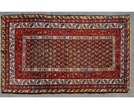 A late 19th century, early 20th century Persian Islamic Veramin handwoven wool carpet rug having large medallion to the centr
