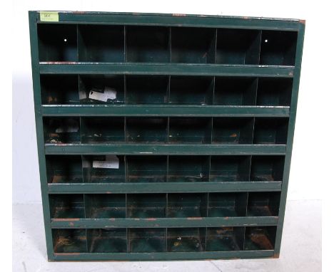 A vintage retro 20th century factory industrial wall mounted pigeon holes metal cabinet finished in green colour from a Jagua