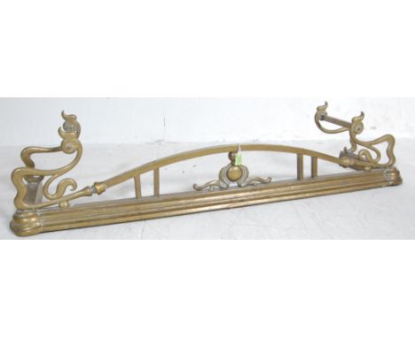 An early 20th century Art Nouveau style brass fire fender kerb. The fender of long rectangular form with Art Nouveau characte