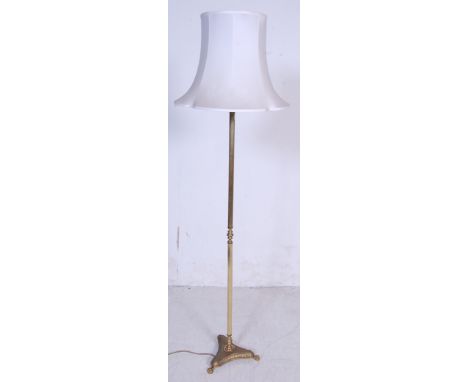 A vintage 1950s mid 20th century brass standard lamp having a reeded column over a stepped base raised on paw feet. Comes wit